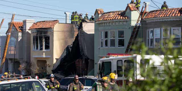 Firefighters battle a house fire after an explosion in the Sunset District on Feb. 9, 2023, in San Francisco, California. The explosion injured a firefighter and a civilian.