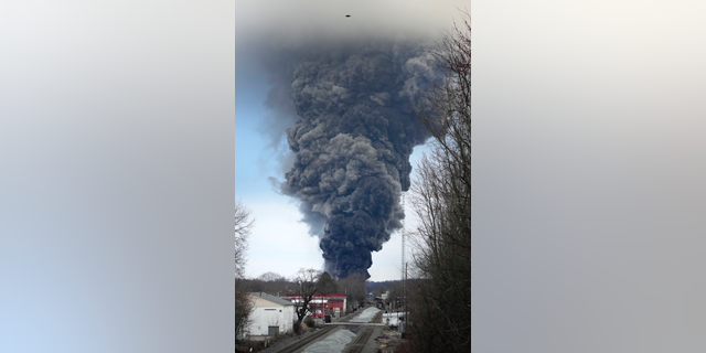 A black plume rises over East Palestine, Ohio, as a result of a controlled detonation of a portion of the derailed Norfolk and Southern trains Monday, Feb. 6, 2023. (AP Photo/Gene J. Puskar)