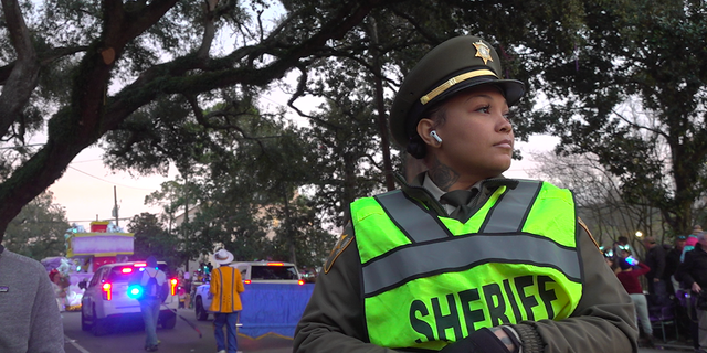 Sgt. Ariel Mercadel with the Orleans Parish Sheriff's Office keeps a watchful eye over the parade crowds. 