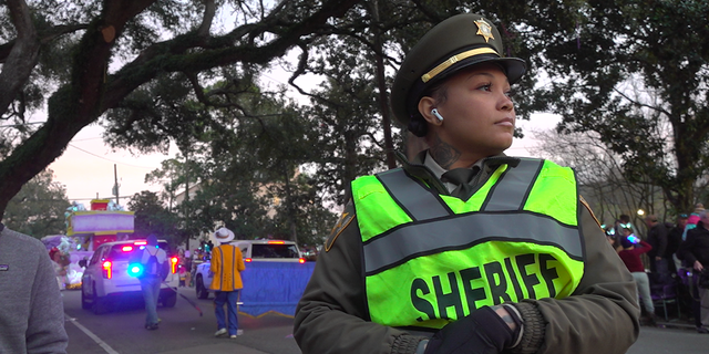 Sgt. Ariel Mercadel with the Orleans Parish Sheriff's Office keeps a watchful eye over the parade crowds.