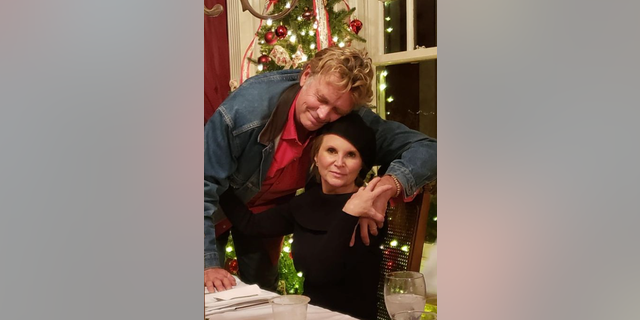 John Schneider continued to reminisce on their life together, as he posted a photo of him and his wife during the holidays. 