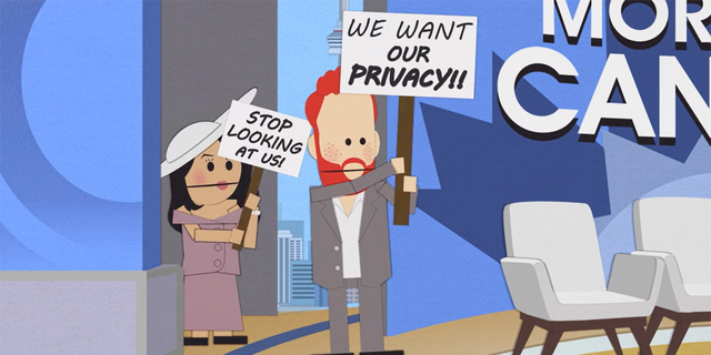 The prince and his wife hold signs that ask the public to respect their privacy.
