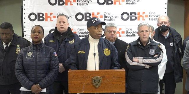 Mayor Eric Adams addresses reporters after the shooting of an off-duty police officer on Feb. 4. A person of interest was in police custody Monday in connection with the shooting. 