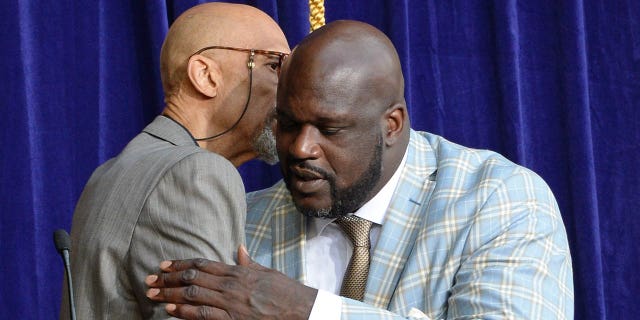 Kareem Abdul-Jabbar, left, and Shaquille O'Neal hug as the Los Angeles Lakers unveil the Shaquille O'Neal statue on March 24, 2017, at Staples Center (now Crypto.com Arena) in Los Angeles.