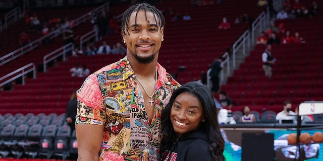 Simone Biles and Jonathan Owens attend a game between the Houston Rockets and the Los Angeles Lakers at Toyota Center Dec. 28, 2021, in Houston.
