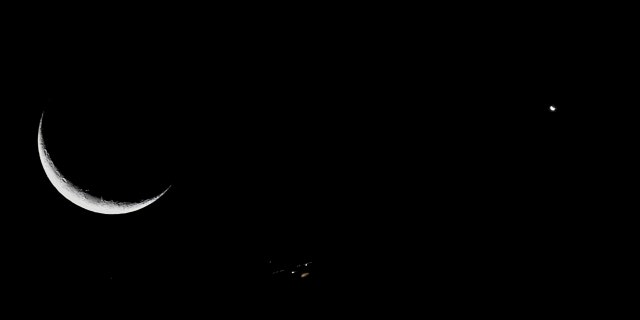 An airplane, center, is seen betwixt nan satellite and Venus successful Santiago, Chile, connected Dec. 6, 2021.