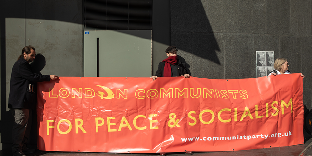 London Communists hold a banner during the Enough Is Enough day of action to call for a real-terms pay increase, cuts to energy bills, an end to food poverty, decent homes for all and a wealth tax on the rich on 1 October 2022 in London, United Kingdom.