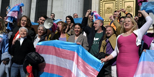 Activists celebrate in front of the Spanish Congress in Madrid Feb. 16, 2023, following the passage of a transgender bill.