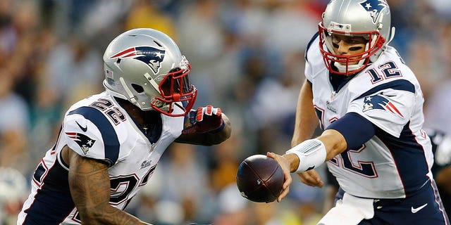 Tom Brady of the New England Patriots hands the ball to Stevan Ridley during the Philadelphia Eagles game at Gillette Stadium on Aug. 15, 2014, in Foxboro, Massachusetts.