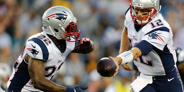 Tom Brady of the New England Patriots hands the ball to Stevan Ridley during the Philadelphia Eagles game at Gillette Stadium on Aug. 15, 2014, in Foxboro, Massachusetts.