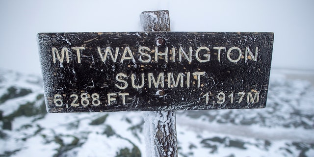 A sign at the summit of Mount Washington informs viewers that they are standing 6,288 feet above sea level. 