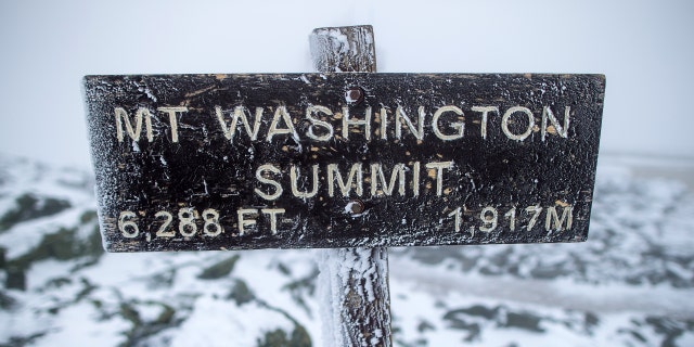 A sign at the summit of Mount Washington informs viewers that they are standing 6,288 feet above sea level. 