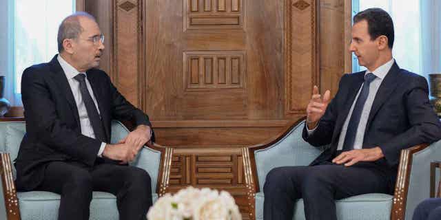 Syrian President Bashar Assad, right, meets Jordanian Foreign Minister Ayman Safadi in Damascus, Syria, on Feb. 15, 2023. Safadi vowed to continue delivering earthquake aid to Syria during the meeting with Assad in Damascus.