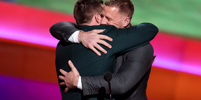 TJ Watt, left, hugs his brother, JJ Watt, as TJ receives the AP Defensive Player of the Year award during the NFL Honors Show at the YouTube Theater on February 10, 2022 in Inglewood, California.