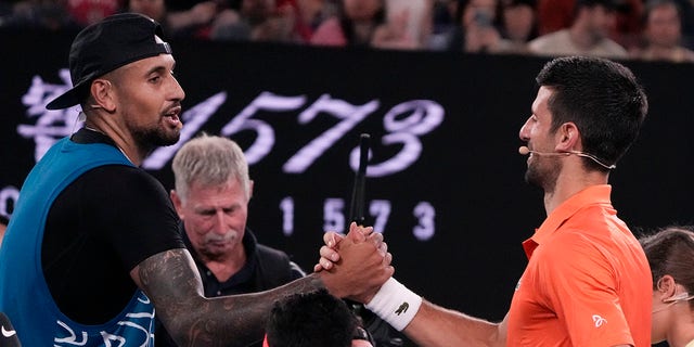 Australia's Nick Kyrgios, left, and Serbia's Novak Djokovic shake hands following an exhibition match at Rod Laver Arena ahead of the Australian Open in Melbourne, Australia, Jan. 13, 2023.