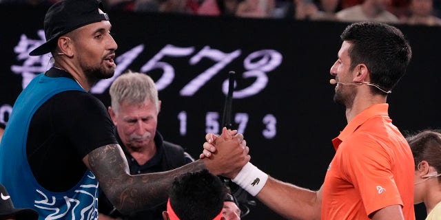 Australia's Nick Kyrgios, left, and Serbia's Novak Djokovic shake hands following an exhibition match at Rod Laver Arena ahead of the Australian Open in Melbourne, Australia, Jan. 13, 2023.