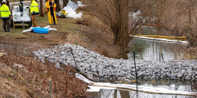 Cleanup continues in a stream in East Palestine Park in East Palestine, Ohio, Thursday, Feb. 16, 2023. Residents of the Ohio village upended by a freight train derailment are demanding to know if they're safe from the toxic chemicals that spilled or were burned off to avoid an even bigger disaster. 