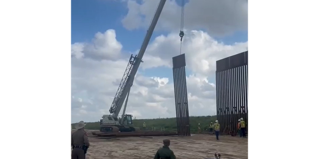 Crews build a wall on the Texas-Mexico border.