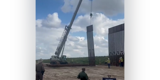 Crews construct a wall along the Texas-Mexico border.