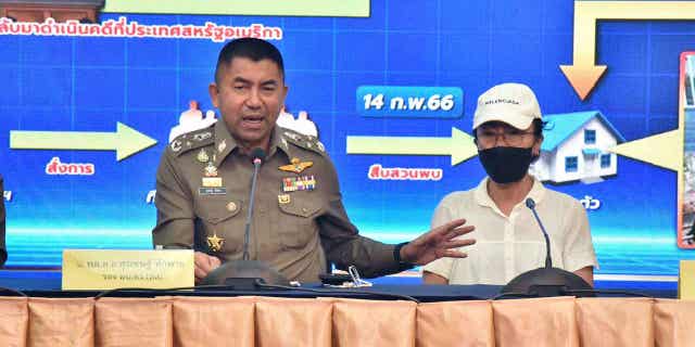 Deputy National Police Chief Surachet Hakpal, left, talks to reporters with Tubtim "Sue" Howson, 57, during press conference at police headquarter in Bangkok, Thailand, Wednesday, Feb. 15, 2023. Howson allegedly struck Michigan State University student Benjamin Kable, 22, shortly before dawn on Jan. 1. She flew to Thailand on a one-way ticket on Jan. 3, according to U.S. authorities. (Royal Thai Police via AP)