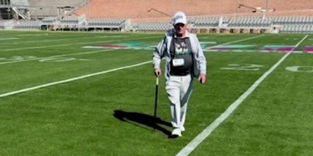 'The Sodfather' George Toma shown walking on a field.