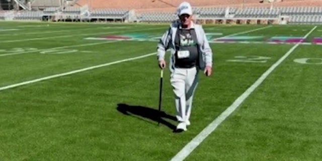 'The Sodfather' George Toma shown walking on a field.