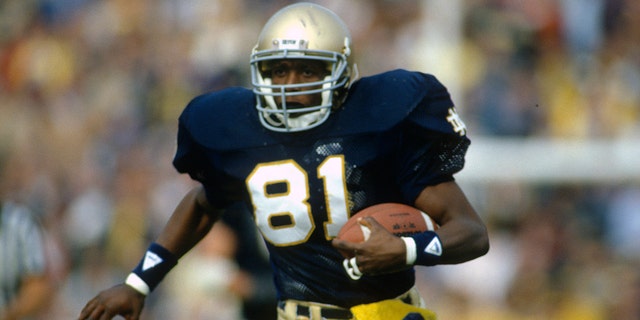 Tim Brown of the Notre Dame Fighting Irish runs with the ball during a game circa 1986 at Notre Dame Stadium in South Bend, Indiana.