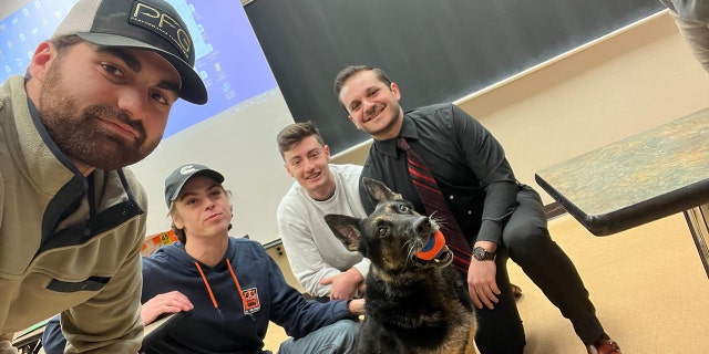 Police K-9 Tole welcomes Michigan State University students back to class following campus shooting in mid-February.