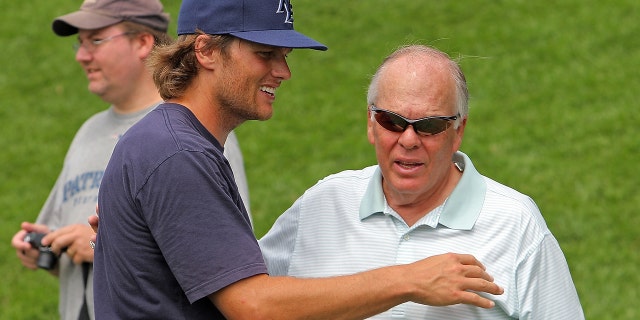 Quarterback Tom Brady gets a birthday hug and kiss from his father, Tom Brady, right, at the end of the New England Patriots' training camp morning session at Gillette Stadium on Tuesday, Aug. 2010. 