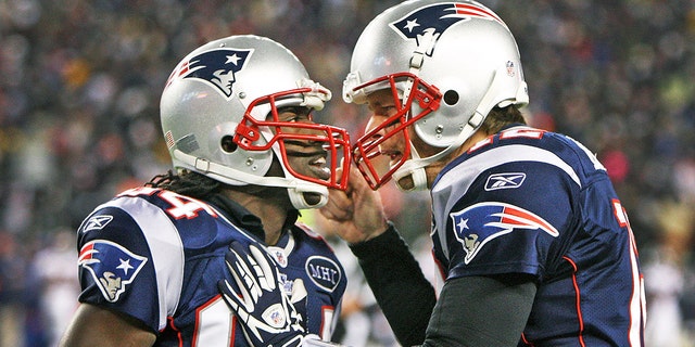 Patriots quarterback Tom Brady, right, celebrates with wide receiver Deion Branch after Branch's second quarter touchdown pass reception. The New England Patriots hosted the Denver Broncos in an NFL AFC Divisional Playoff game at Gillette Stadium in Foxborough, Massachusetts, on Saturday, Jan. 14, 2011.
