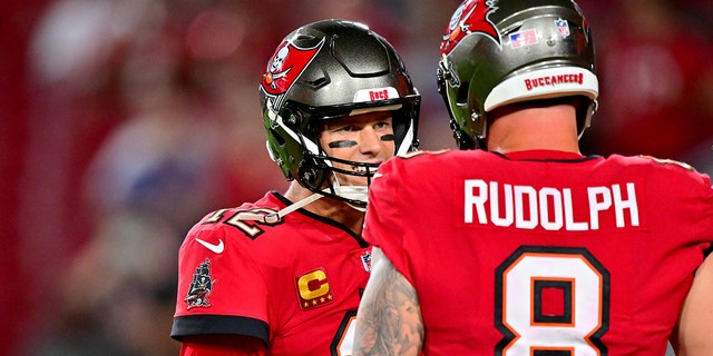 Tom Brady of the Buccaneers talks with Kyle Rudolph before the New Orleans Saints game at Raymond James Stadium on Dec. 5, 2022, in Tampa, Florida.