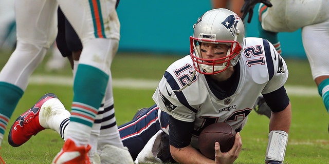 Tom Brady of the New England Patriots after getting sacked during the third quarter of a game against the Miami Dolphins at Hard Rock Stadium Dec. 9, 2018, in Miami Gardens, Fla.