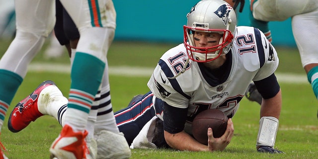 Tom Brady of the New England Patriots after getting sacked during the third quarter of a game against the Miami Dolphins at Hard Rock Stadium Dec. 9, 2018, in Miami Gardens, Fla.