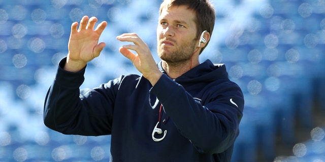 New England Patriots number 12 Tom Brady warms up before the first half against the Buffalo Bills at Ralph Wilson Stadium on October 12, 2014 in Orchard Park, New York.