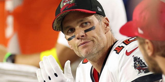 Tom Brady, #12 of the Tampa Bay Buccaneers, reacts on the bench during the 4th quarter of the game against the Arizona Cardinals at State Farm Stadium on Dec. 25, 2022 in Glendale, Arizona.