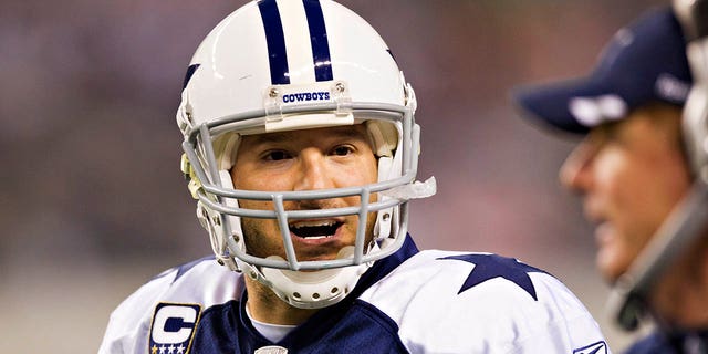 Tony Romo #9 talks with Dallas Cowboys head coach Jason Garrett during a game against the Miami Dolphins at Cowboys Stadium on November 24, 2011 in Arlington, Texas.