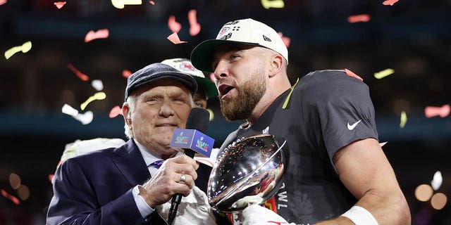 Travis Kelce #87 of the Kansas City Chiefs celebrates with the Vince Lombardi Trophy after defeating the Philadelphia Eagles 38-35 in Super Bowl LVII at State Farm Stadium on February 12, 2023 in Glendale, Arizona.