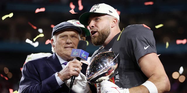Travis Kelce #87 of the Kansas City Chiefs celebrates with the the Vince Lombardi Trophy after defeating the Philadelphia Eagles 38-35 in Super Bowl LVII at State Farm Stadium on February 12, 2023 in Glendale, Arizona.