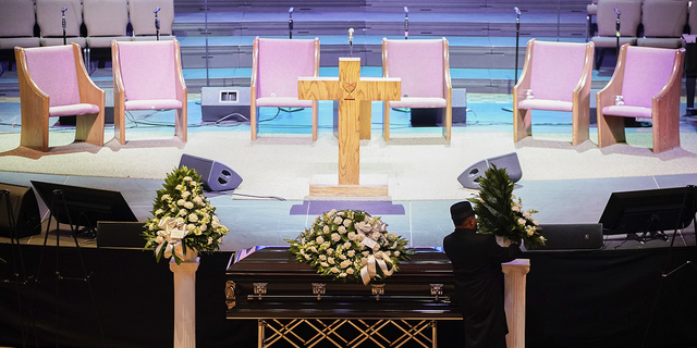 A man arranges flowers around Tyre Nichols' casket at the Mississippi Boulevard Christian Church in Memphis, Tennessee, on Wednesday, Feb. 1.