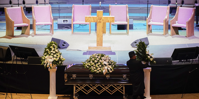 A man arranges flowers around Tyre Nichols' casket at the Mississippi Boulevard Christian Church in Memphis, Tennessee, on Wednesday, Feb. 1.
