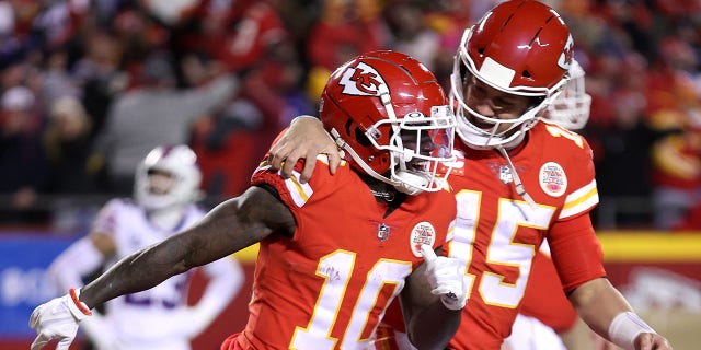 Tyreek Hill #10 of the Kansas City Chiefs celebrates with teammate Patrick Mahomes #15 after scoring a 64 yard touchdown against the Buffalo Bills during the fourth quarter in the AFC Divisional Playoff game at Arrowhead Stadium on Jan. 23, 2022 in Kansas City, Missouri.