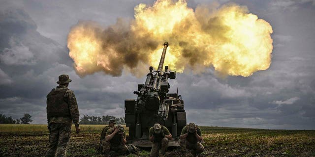 Ukrainian servicemen fire with a French self-propelled 155 mm/52-calibre gun Caesar towards Russian positions at a front line in the eastern Ukrainian region of Donbas on June 15, 2022.