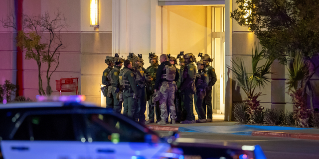 Police officers gather at an entrance of a shopping mall, Wednesday, Feb. 15, 2023, in El Paso, Texas. Police say one person was killed and three other people were wounded in a shooting at Cielo Vista Mall. One person has been taken into custody, El Paso police spokesperson Sgt. Robert Gomez said. 