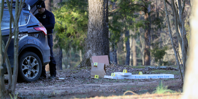 Law enforcement personnel investigate the scene of multiple shootings on Arkabutla Dam Road in Arkabutla, Miss on Friday, Feb. 17, 2023. Six people were fatally shot Friday at multiple locations in a small town in rural Mississippi near the Tennessee state line, and authorities blamed a lone suspect who was arrested and charged with murder. 