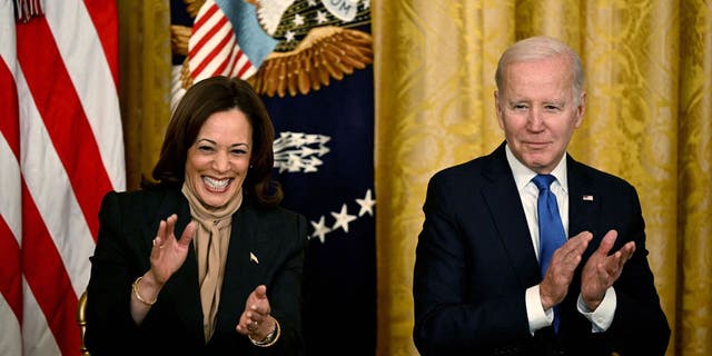 US Vice President Kamala Harris and US President Joe Biden applaud during an event marking the 30th Anniversary of the Family and Medical Leave Act, in the East Room of the White House in Washington, D.C, on February 2, 2023.