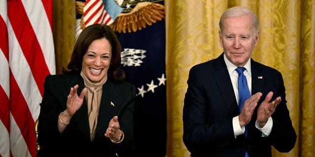 US Vice President Kamala Harris and US President Joe Biden applaud during an event marking the 30th Anniversary of the Family and Medical Leave Act, in the East Room of the White House in Washington, D.C, on February 2, 2023.