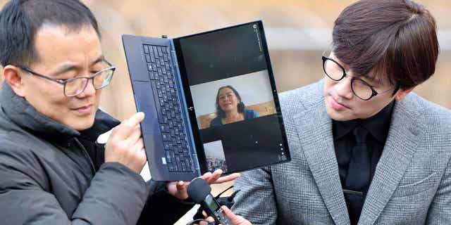 Vietnamese woman Nguyen Thi Thanh is seen on a computer monitor as she speaks outside the court in Seoul, South Korea, on Feb. 7, 2023. A South Korean court ordered the government to pay $24,000 to Nguyen Thi Thanh, who survived a gunshot wound but lost several relatives, when her village was raided during the Vietnam War.