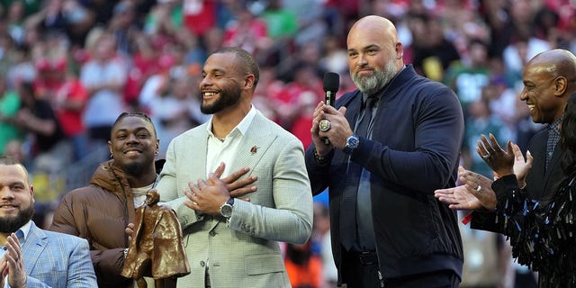 Dak Prescott accepts the Walter Payton Man of the Year award from Andrew Whitworth during Super Bowl LVII at State Farm Stadium on February 12, 2023 in Glendale, Arizona.