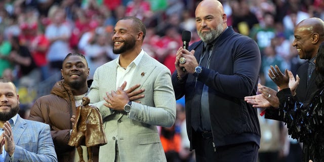 Dak Prescott accepts the Walter Payton Man of the Year award from Andrew Whitworth during Super Bowl LVII at State Farm Stadium on February 12, 2023 in Glendale, Arizona.