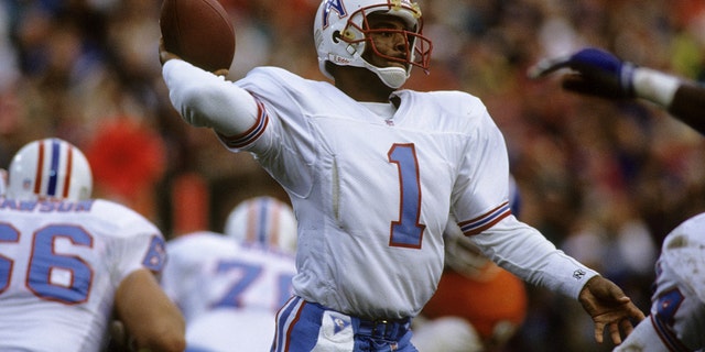 Houston Oilers quarterback Warren Moon (1), elected to the Pro Football Hall of Fame class of 2006, fires a pass during the AFC Divisional Playoff, a 26-24 loss to the Denver Broncos on January 4, 1992, at Mile High Stadium in Denver, Colorado.